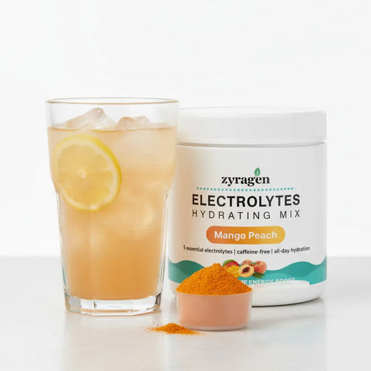 A tub of Zyragen Electrolytes in Mango Peach flavor, a glass with a light orange drink and a scoop of orange powder