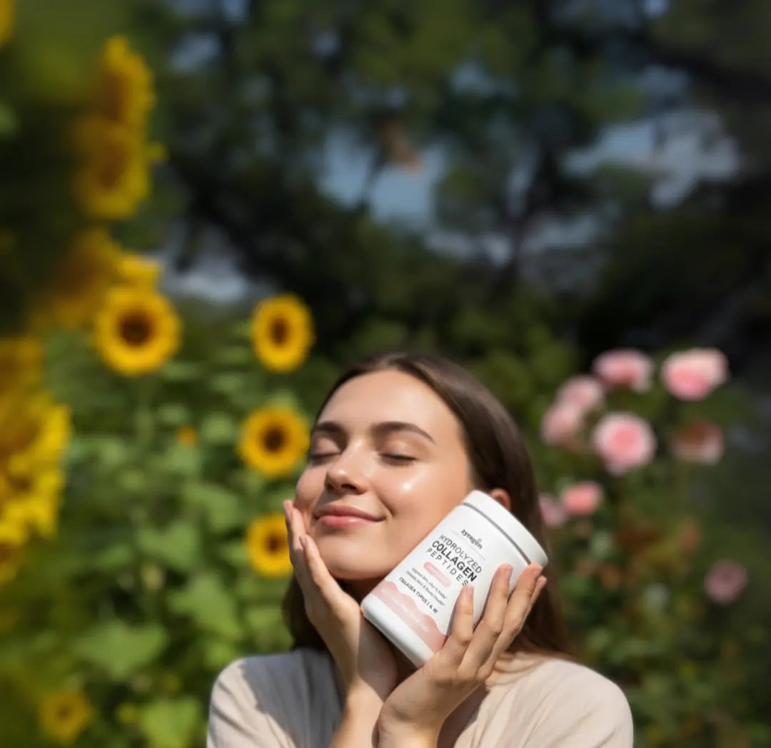 Woman holding a container of Zyragen Hydrolyzed Collagen Peptides in a garden with sunflowers and pink flowers.