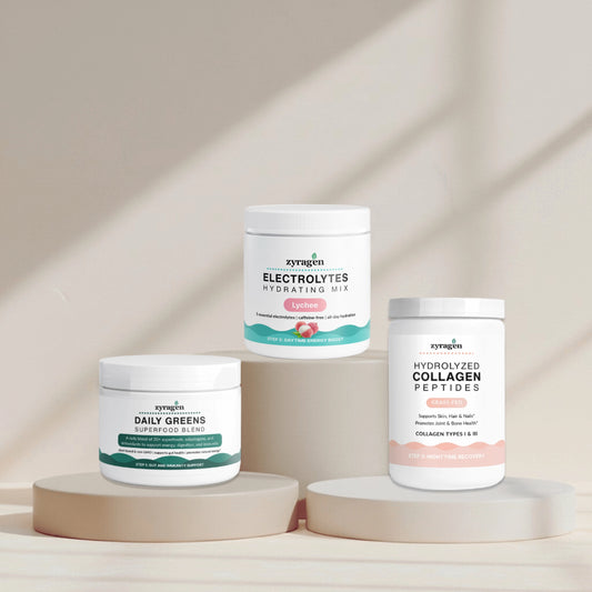 Zyragen The Daily Ritual supplement containers on a neutral background. A tub of Daily Greens, a tub of Electrolytes in Lychee flavor and a tub of Collagen.