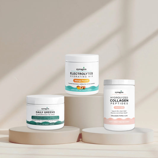 Zyragen The Daily Ritual supplement containers on a neutral background. A tub of Daily Greens, a tub of Electrolytes in Mango Peach flavor and a tub of Collagen.